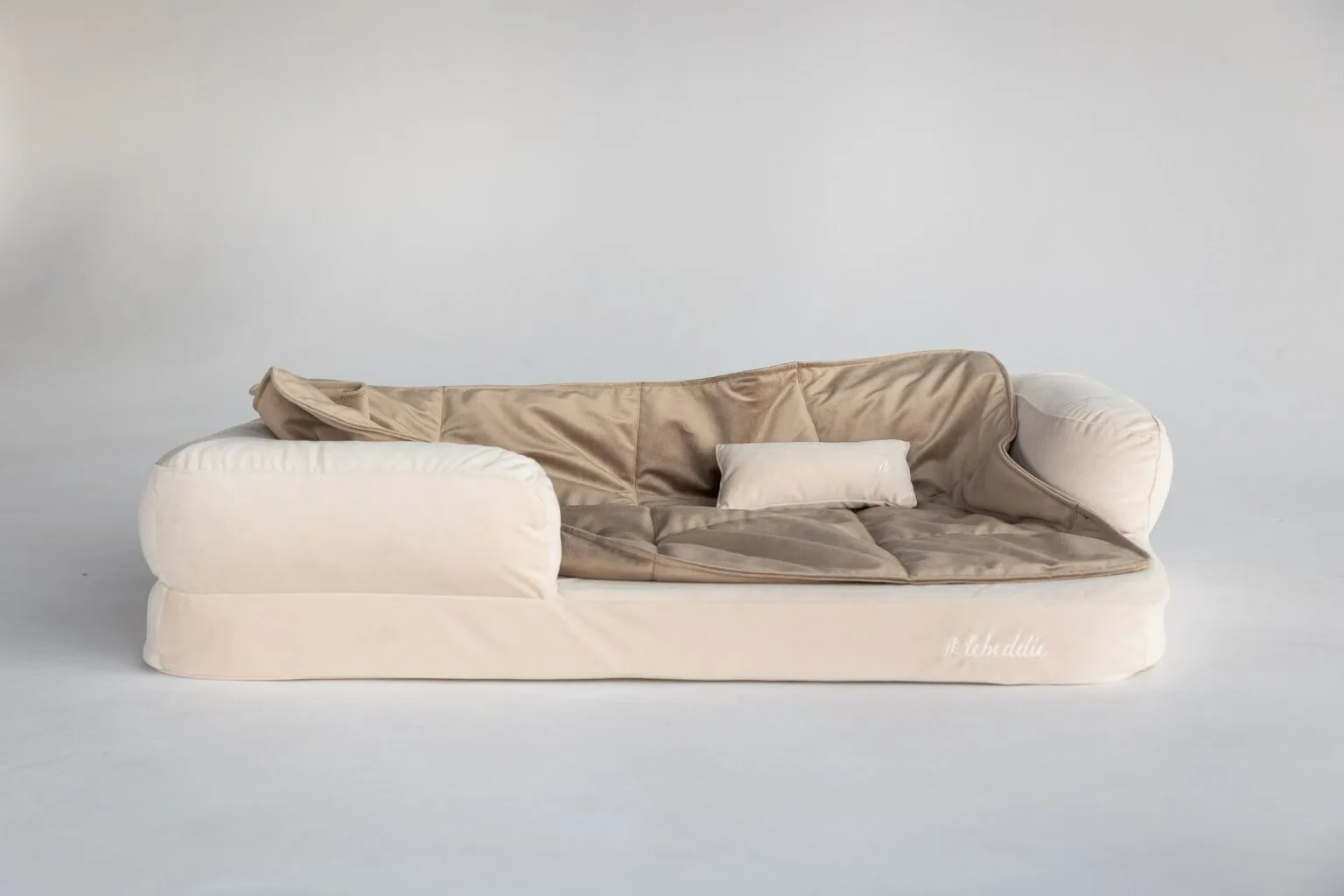 Cream Snug bed with cream cushion and brown blanket